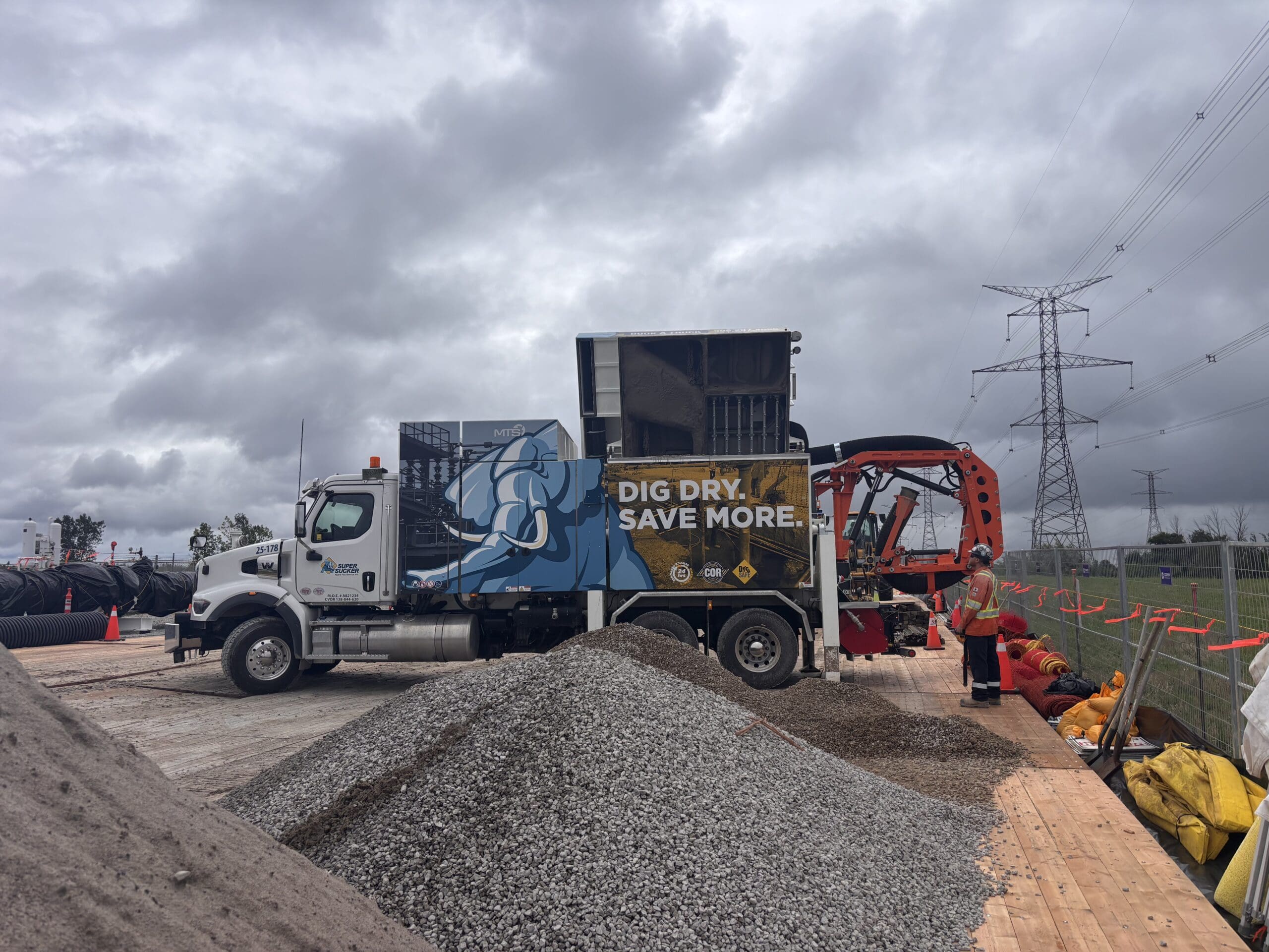 Vacuum excavation equipment unloading recovered material on site